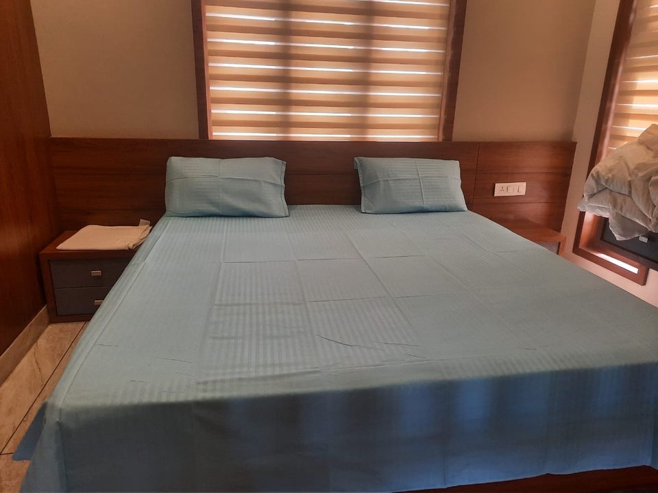 The second cottage's bedroom, a double bed under a slatted window